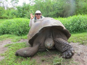 Harry with an endemic Giant Galapagos tortoise in the wild in Santa Cruz Highlands